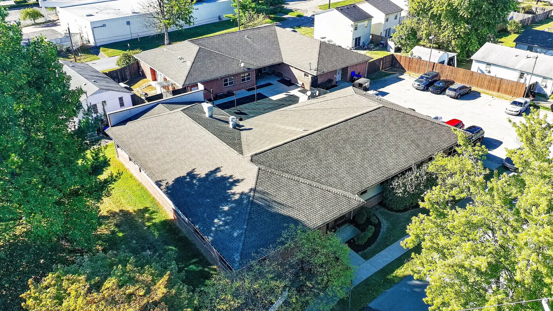 Aerial view of the Golden Grove Recovery building on Malcolm Ave in Louisville, framed by mature trees.