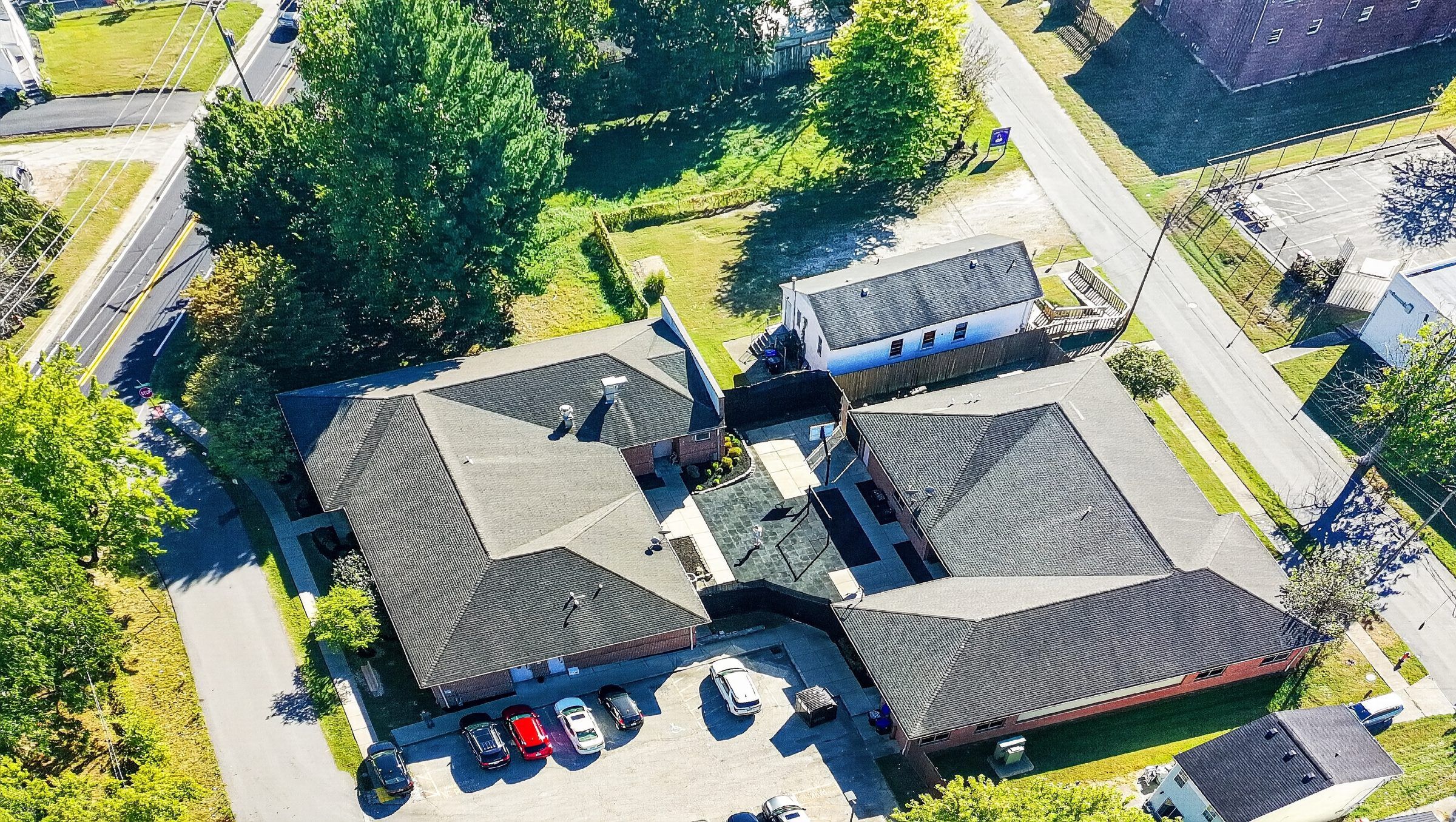 Aerial view of the Golden Grove Recovery building on Malcolm Ave in Louisville, framed by mature trees.