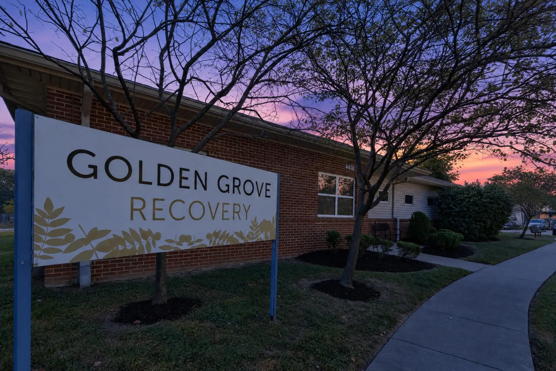 The Golden Grove Recovery sign outside the building on Malcolm Ave at dusk.