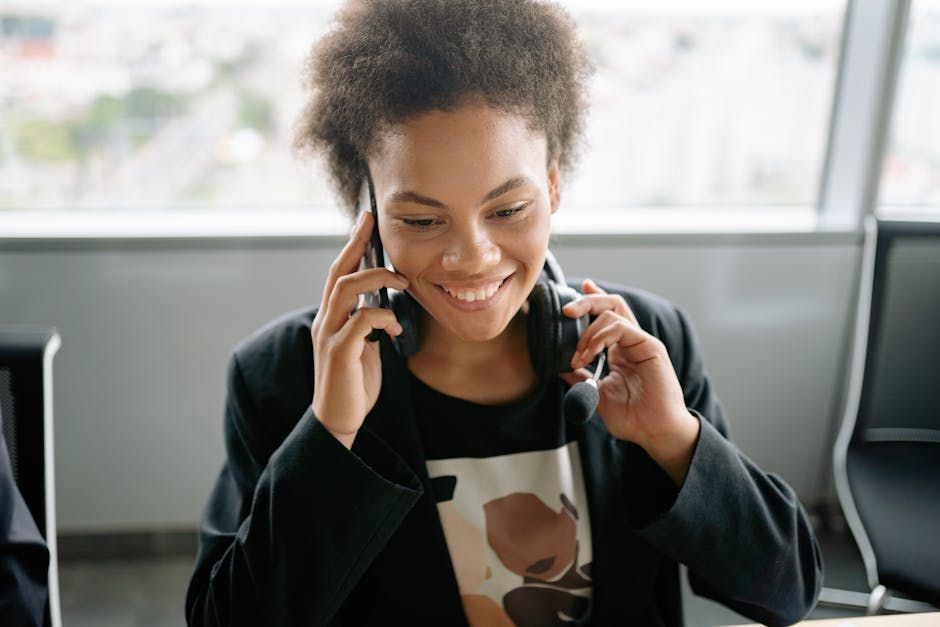 A warm, smiling admissions counselor on the phone ready to help.